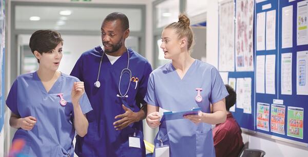 Group of nurses walking in hallway
