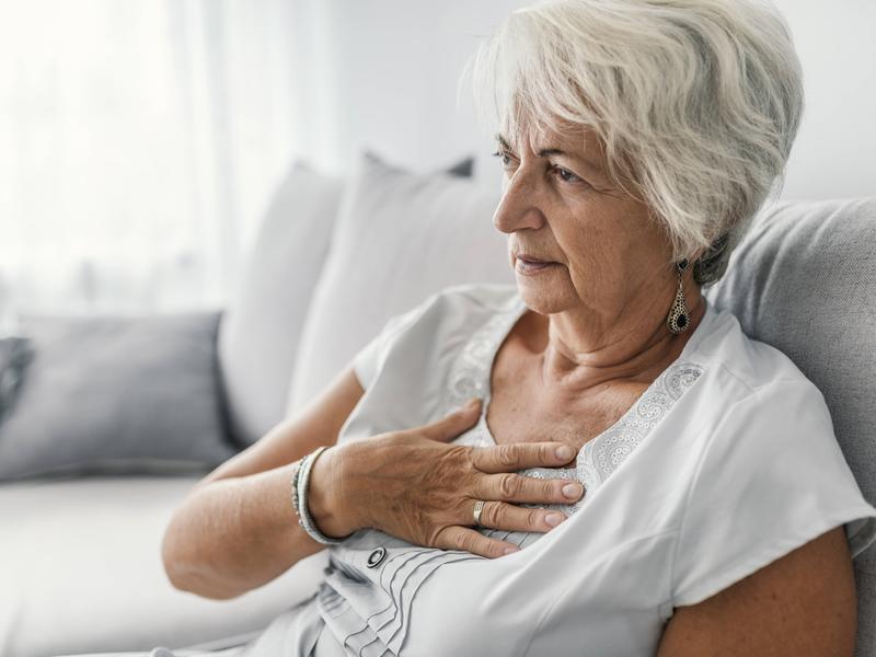 elderly woman grabbing her chest