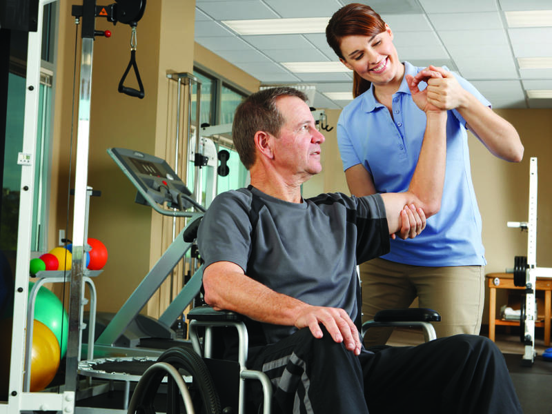 Man in wheelchair doing exercise