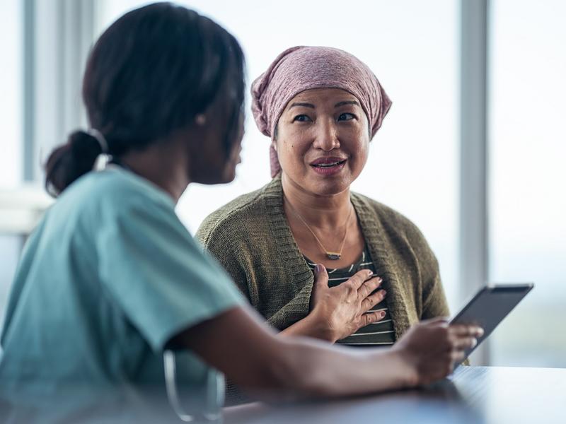 Woman cancer patient talking to doctor.