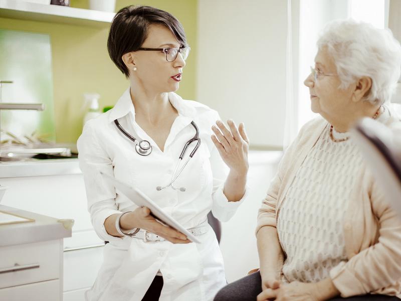 elderly woman talking to doctor