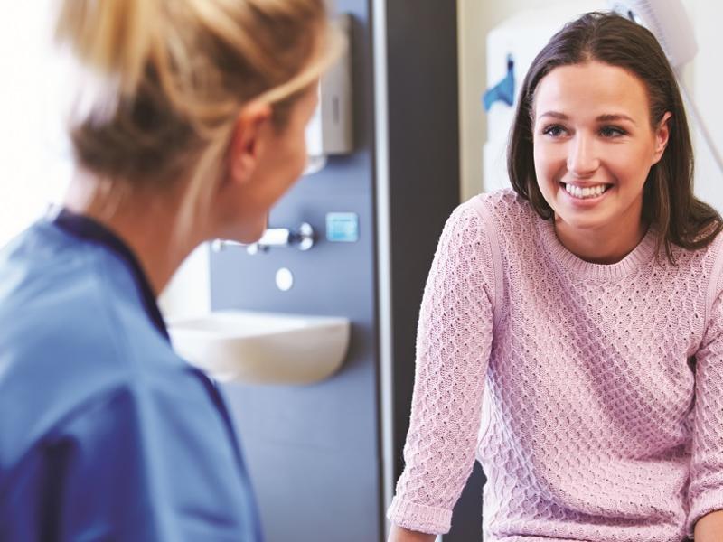 Woman doctor talking with woman patient