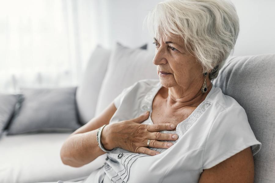 elderly woman grabbing her chest