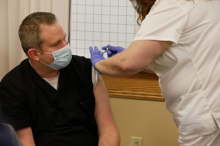 Adam Crawford, MD, receiving vaccine