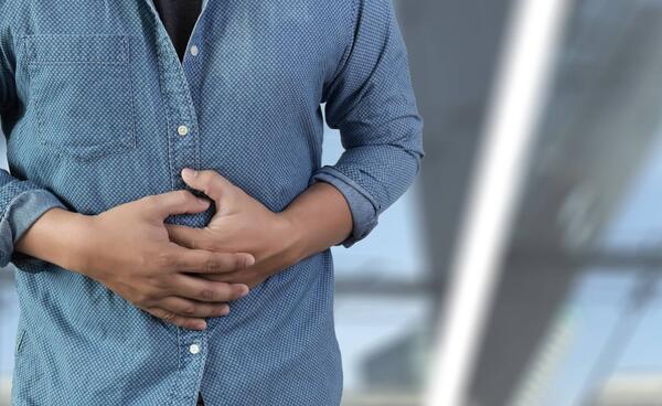 woman holding her stomach in pain