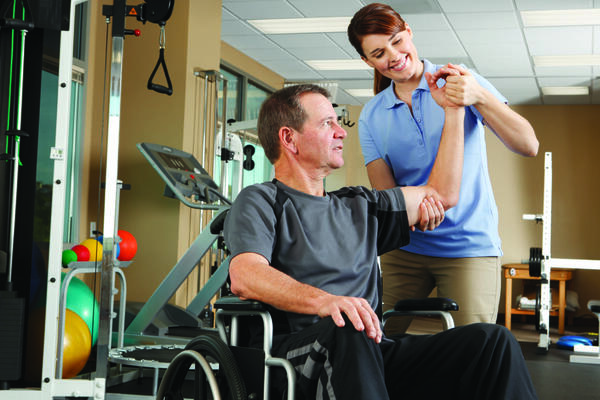 Man in wheelchair doing exercise