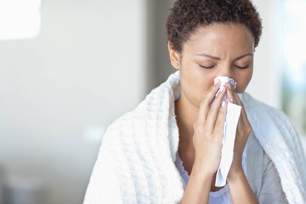 woman blowing her nose