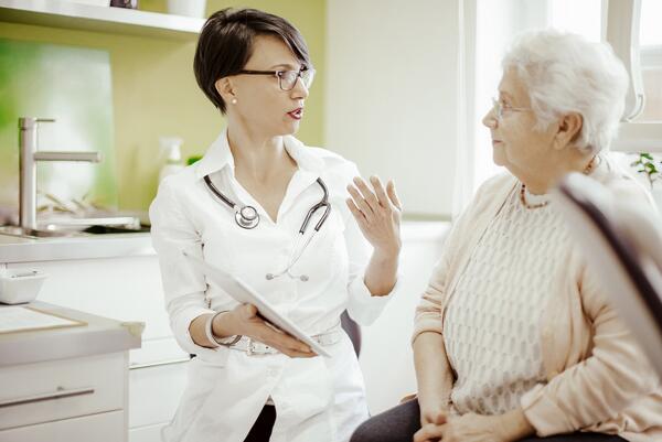 elderly woman talking to doctor