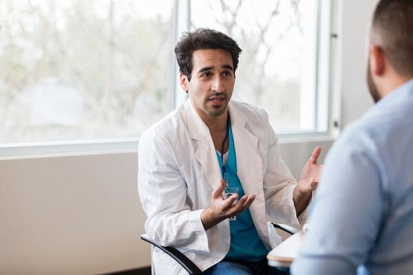 Male doctor in a conversation with male patient.